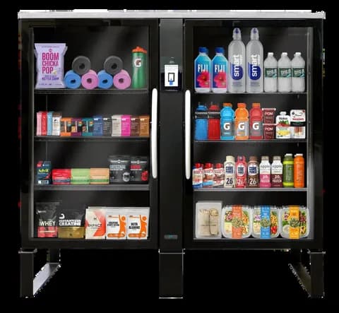 Double-door smart fridge stocked with drinks, snacks, and wellness items